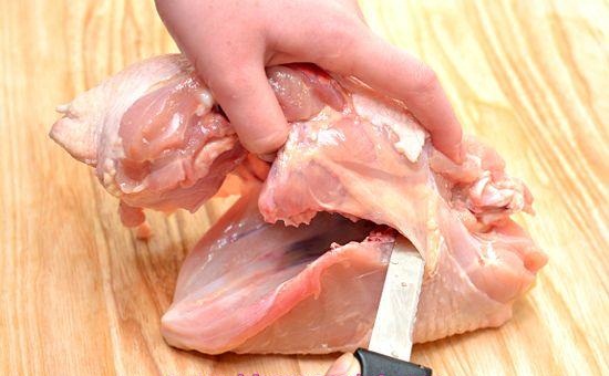 
بوسیله چاقو موازی ستون فقرات مرغ برش داده و استخوان های قفسه سینه را جا کنید.
